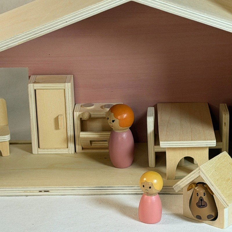 Peg dolls playing in the wooden dollhouse