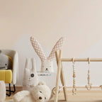 Wooden play gym with plush friends in nursery