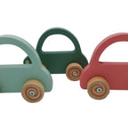 Three colorful wooden toy cars on a white background