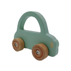 Green toy car with wooden wheels on a light gray background