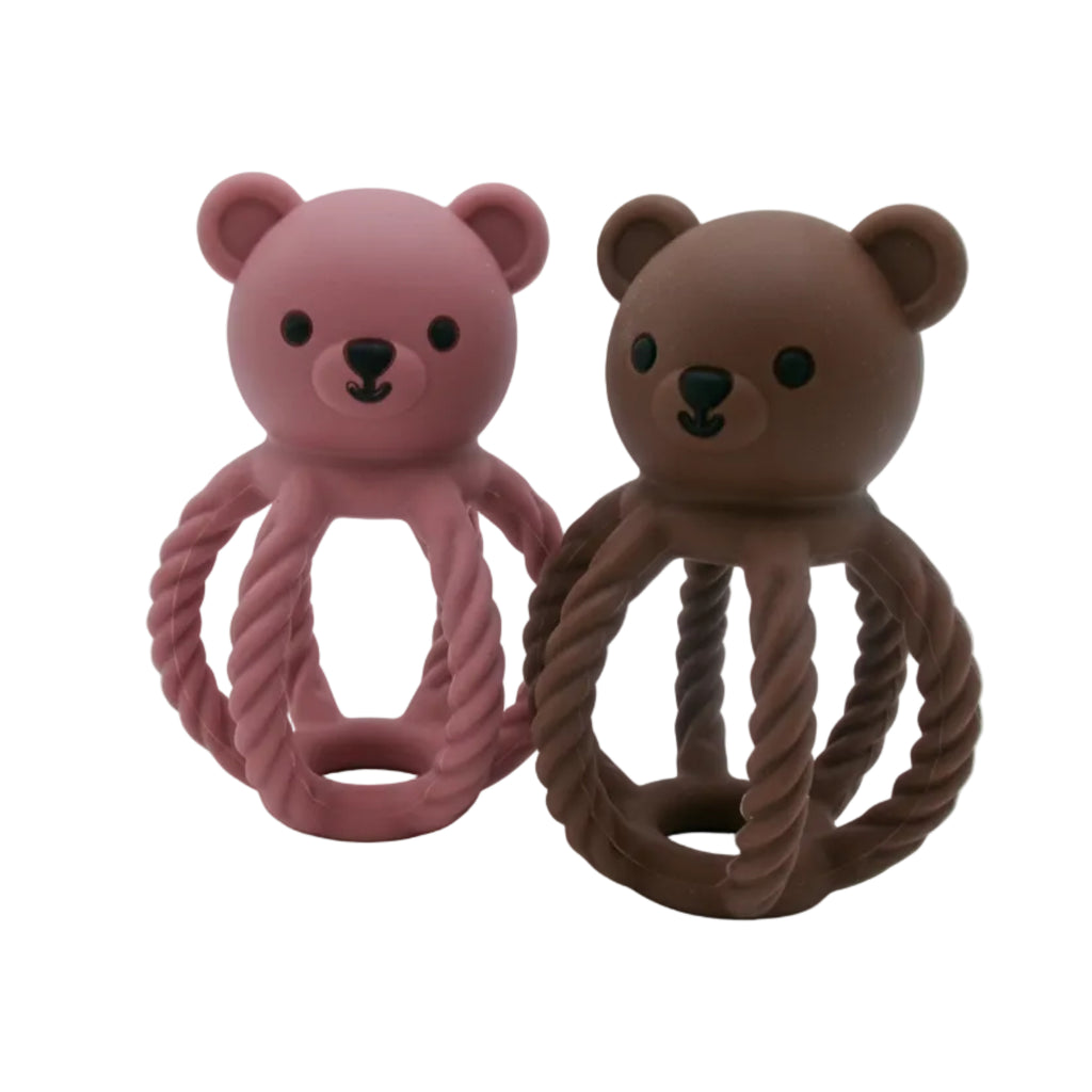 Two bear-shaped toys with rope handles, one pink and one brown, on a white background.