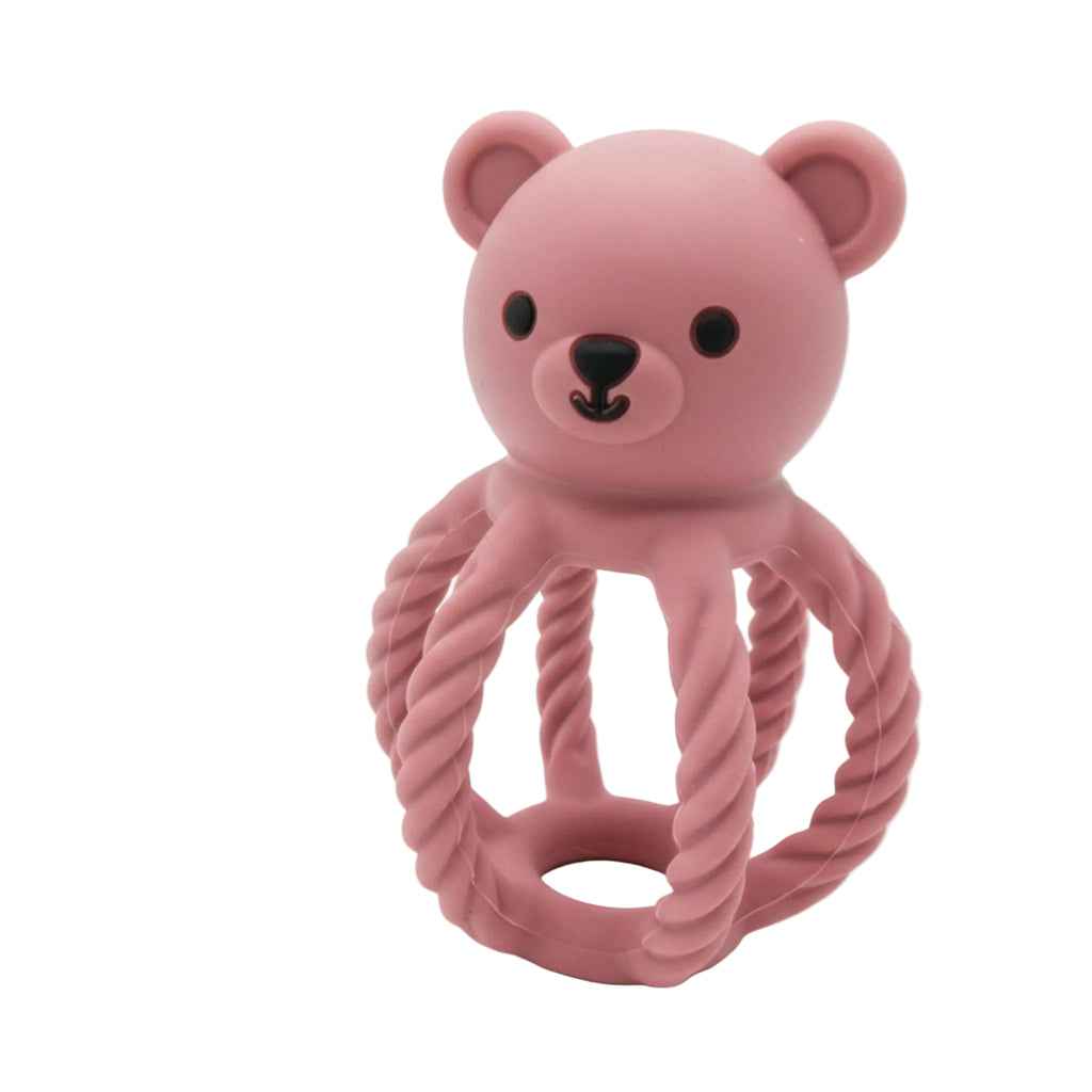 Pink bear-shaped toy with a rope on a white background