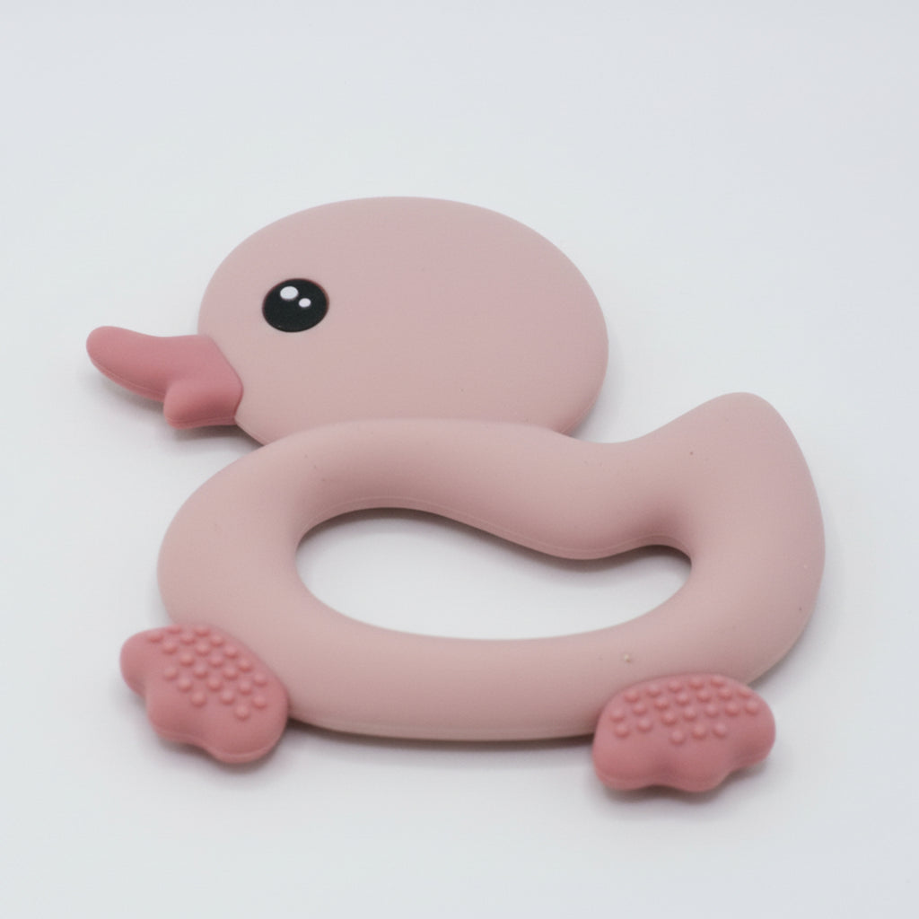 Pink rubber duck teether on a white background