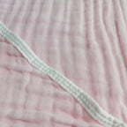 Close-up of pink textured fabric with a green elastic band