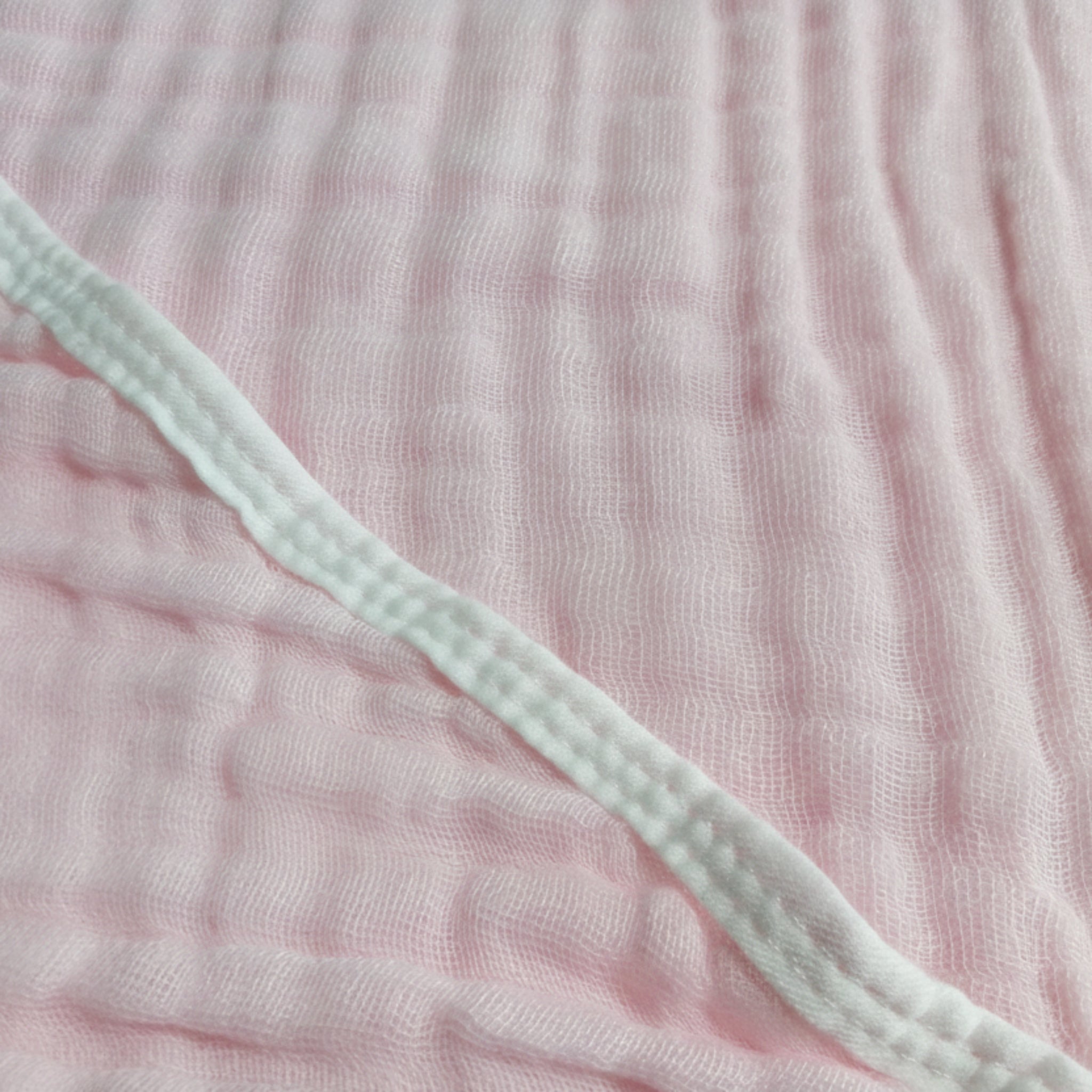 Close-up of pink textured fabric with a green elastic band