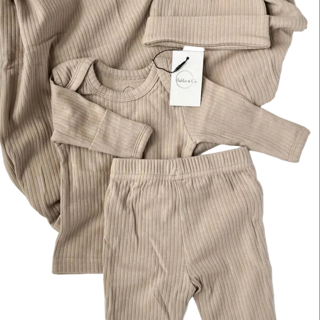 Beige ribbed baby outfit with matching hat and pants on a white background, featuring the brand 'Bubba & Co'.