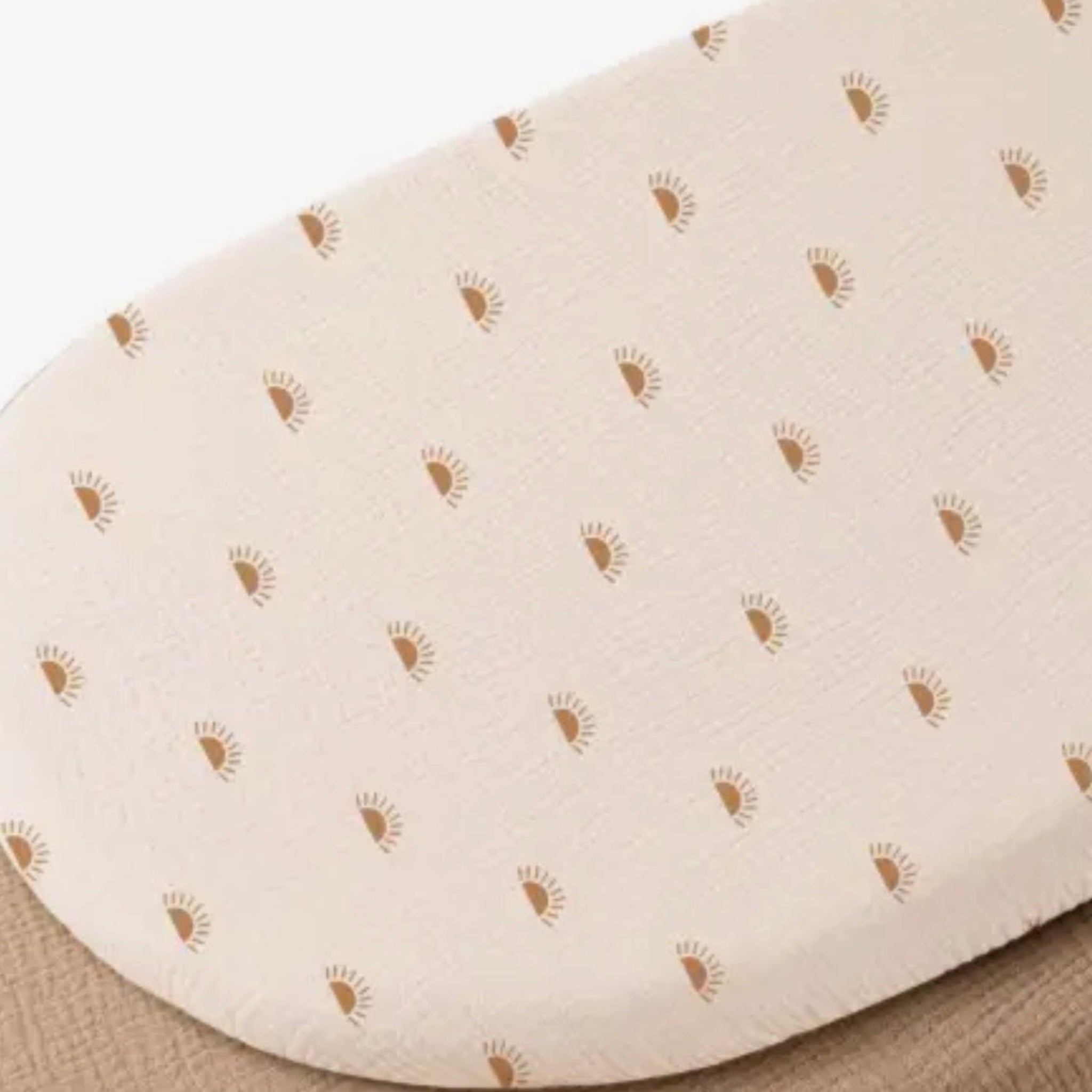 Beige bath mat with small brown patterns on a textured surface