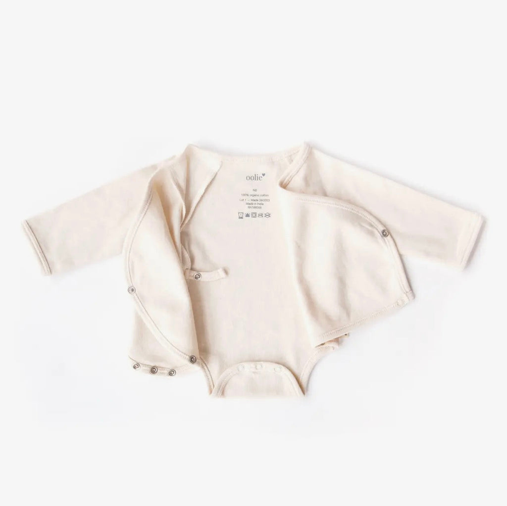 Beige baby bodysuit with short sleeves on a white background