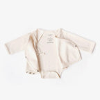Beige baby bodysuit with short sleeves on a white background