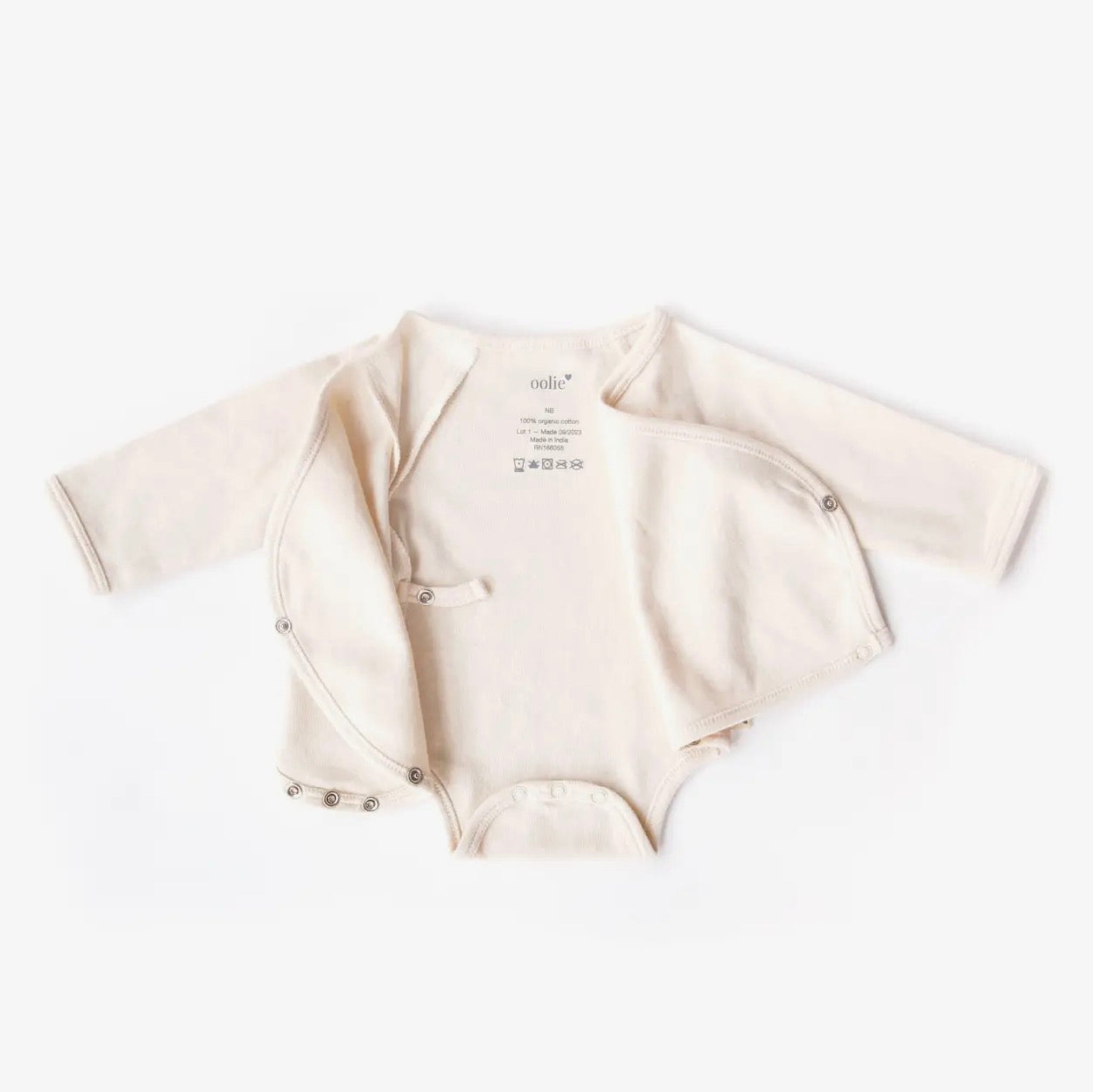 Beige baby bodysuit with short sleeves on a white background