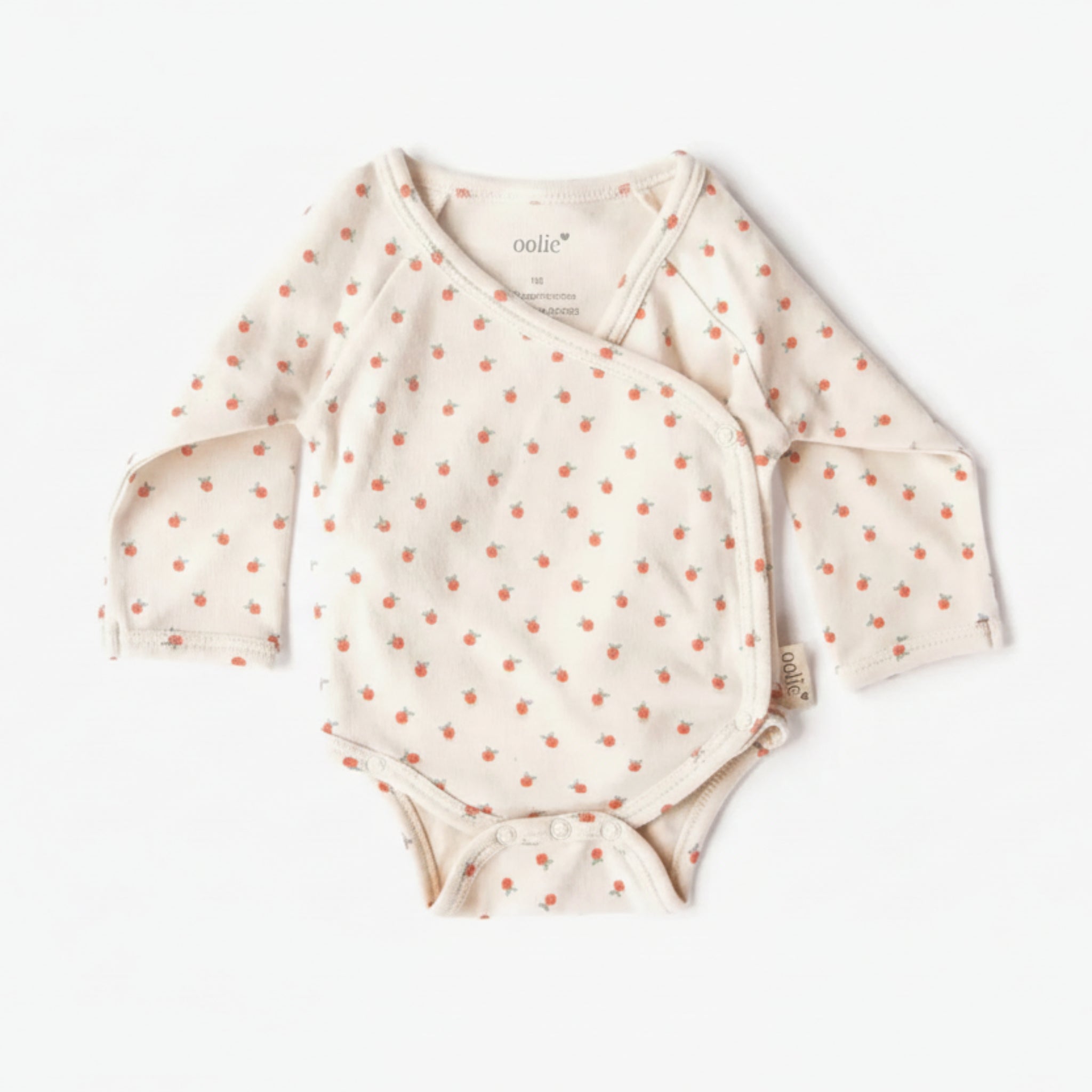 Baby onesie with long sleeves and small patterns on a white background