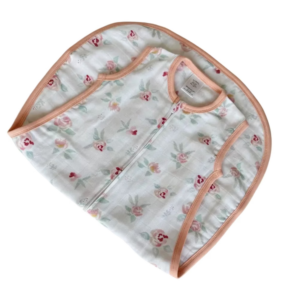 Baby romper with floral pattern on a white surface