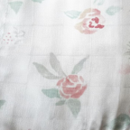 Floral patterned fabric with a brown border on a light background
